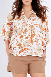 Model Laura wearing size 14 of The Frills You Give Me Blouse in colour Rustfleur (White), from the front, cropped image