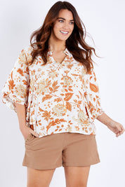 Model Laura wearing size 14 of The Frills You Give Me Blouse in colour Rustfleur (White), from the front, cropped image