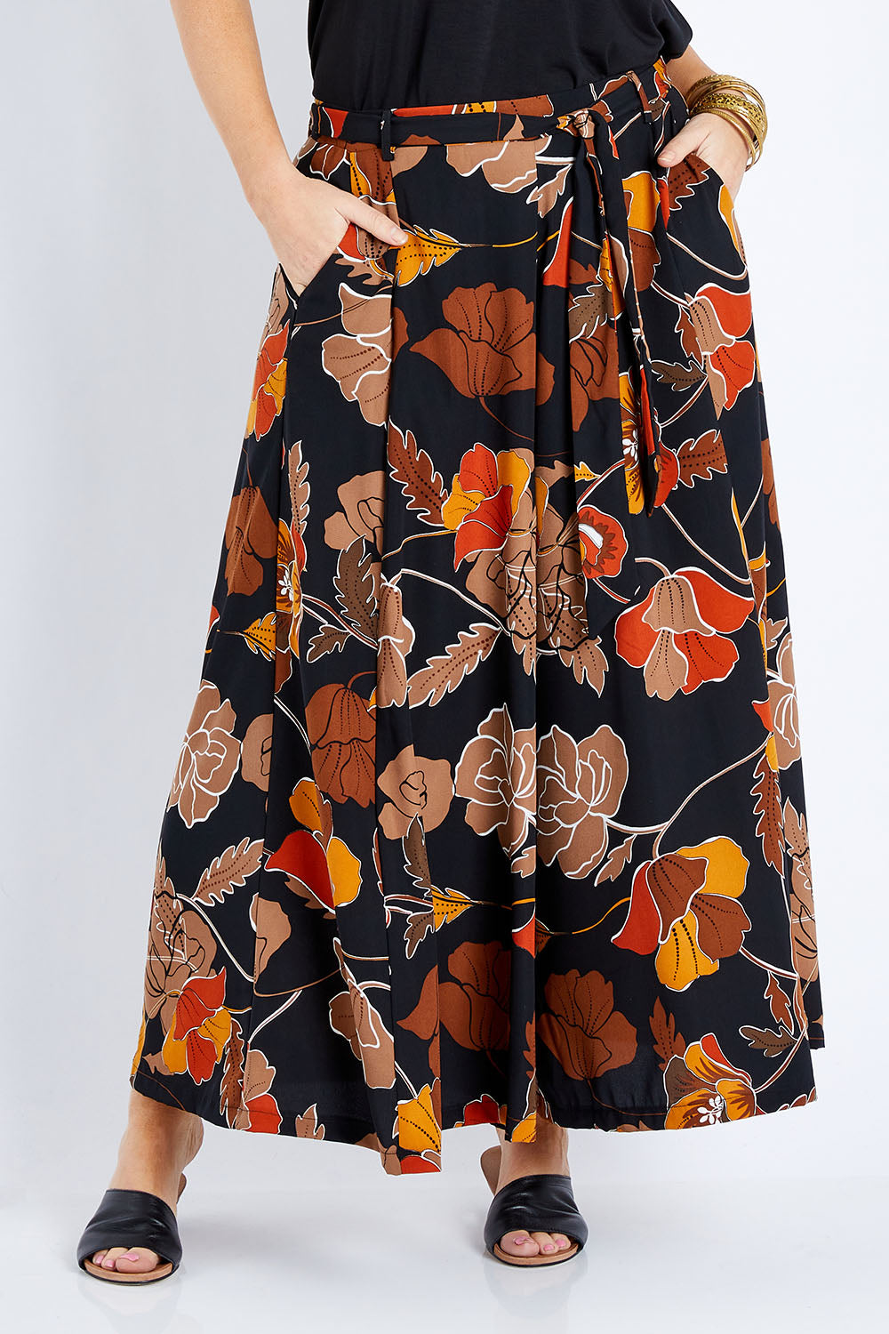Model Laura wearing size 14 of the Walk This Way Wide Leg Pants in colour Blackrust (Black), from the front, cropped image