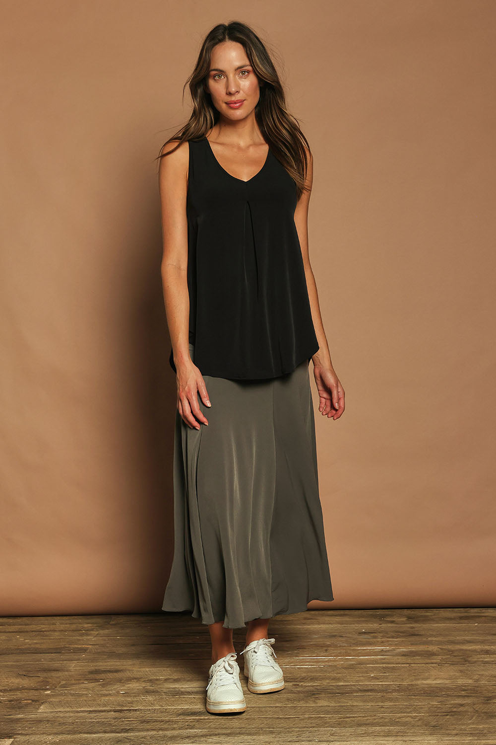 Model Madeline wearing size 10 of The Wanderer In Me V Neck Travel Singlet in colour Black (Black), from the front, showing the whole outfit