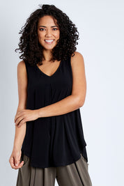 Model Pamela wearing size 10 of The Wanderer In Me V Neck Travel Singlet in colour Black (Black), from the front, cropped image