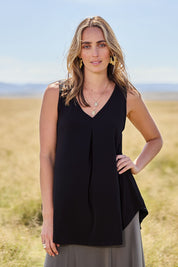 Model Tegan wearing size 10 of The Wanderer In Me V Neck Travel Singlet in colour Black (Black), from the front, showing the whole outfit
