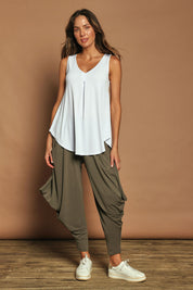 Model Madeline wearing size 10 of The Wanderer In Me V Neck Travel Singlet in colour White (White), from the front, showing the whole outfit