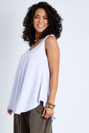 Model Pamela wearing size 10 of The Wanderer In Me V Neck Travel Singlet in colour White (White), from the front, cropped image