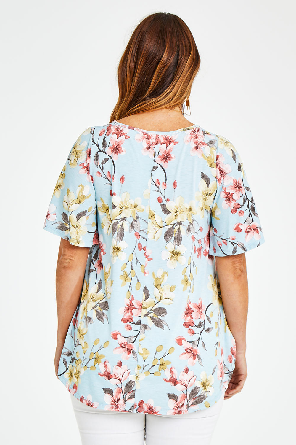 Model Laura wearing size 14 of the Free Falling Top in colour Blossom (Blue), from the back
