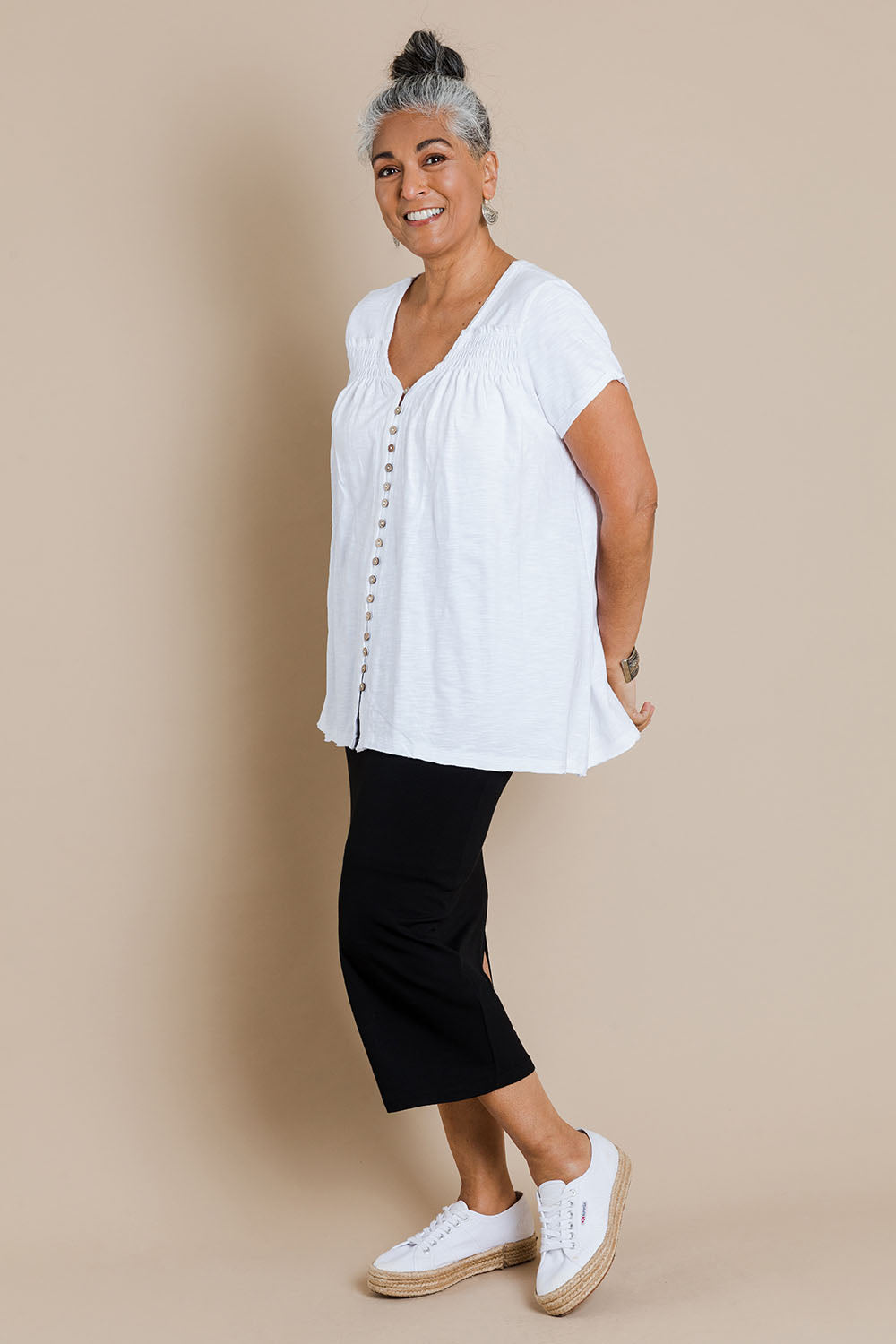 Model Nadine wearing size 10 of the Softly Swinging Bamboo Tube Skirt in colour Black (Black), from the front, showing the whole outfit