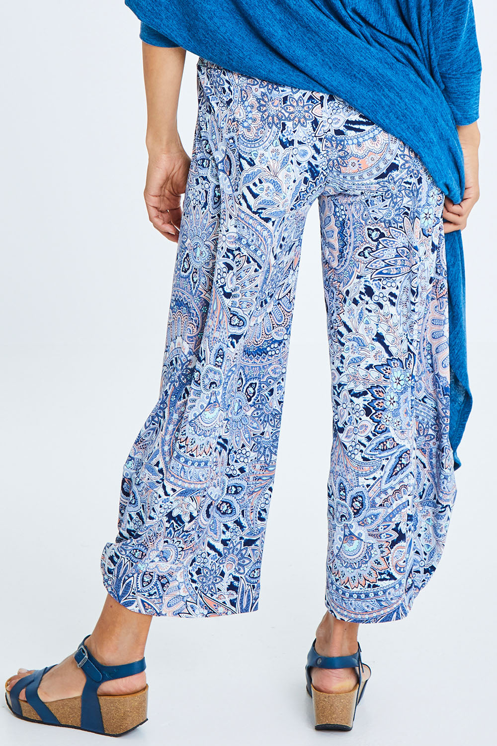 Model Cara wearing size 10 of the Good Vibes Balloon Hem Pants in colour Blues (Blue), from the back