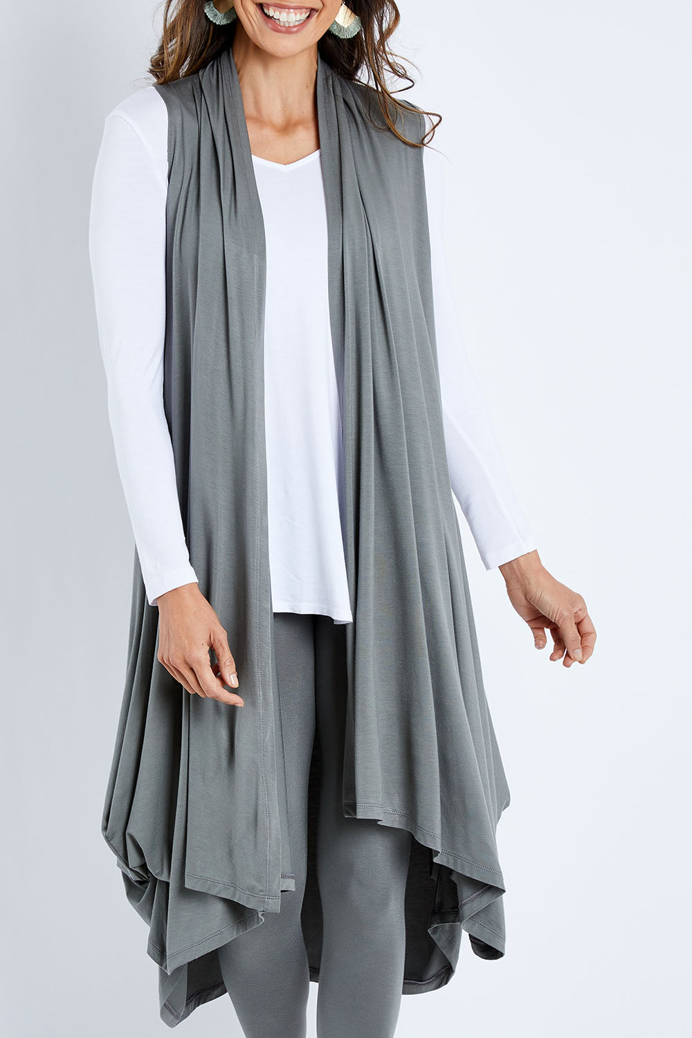 Model Amanda wearing size 10 of the Softly Swinging Bamboo Vest in colour Fern (Green), from the front, cropped image