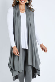 Model Amanda wearing size 10 of the Softly Swinging Bamboo Vest in colour Fern (Green), from the front, cropped image