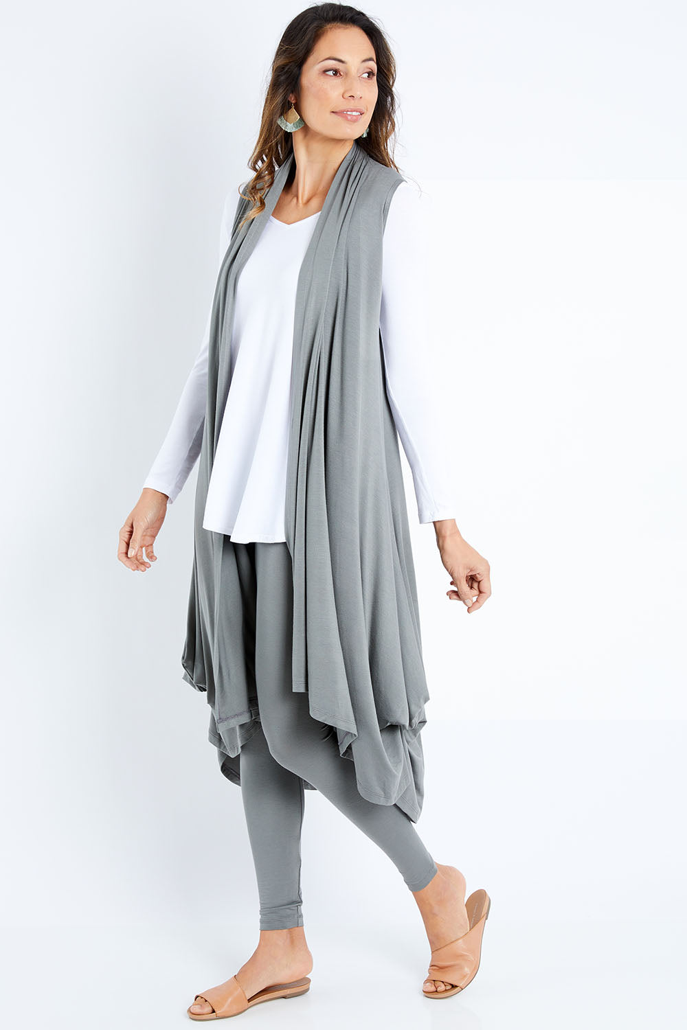 Model Amanda wearing size 10 of the Softly Swinging Bamboo Vest in colour Fern (Green), from the front, showing the whole outfit
