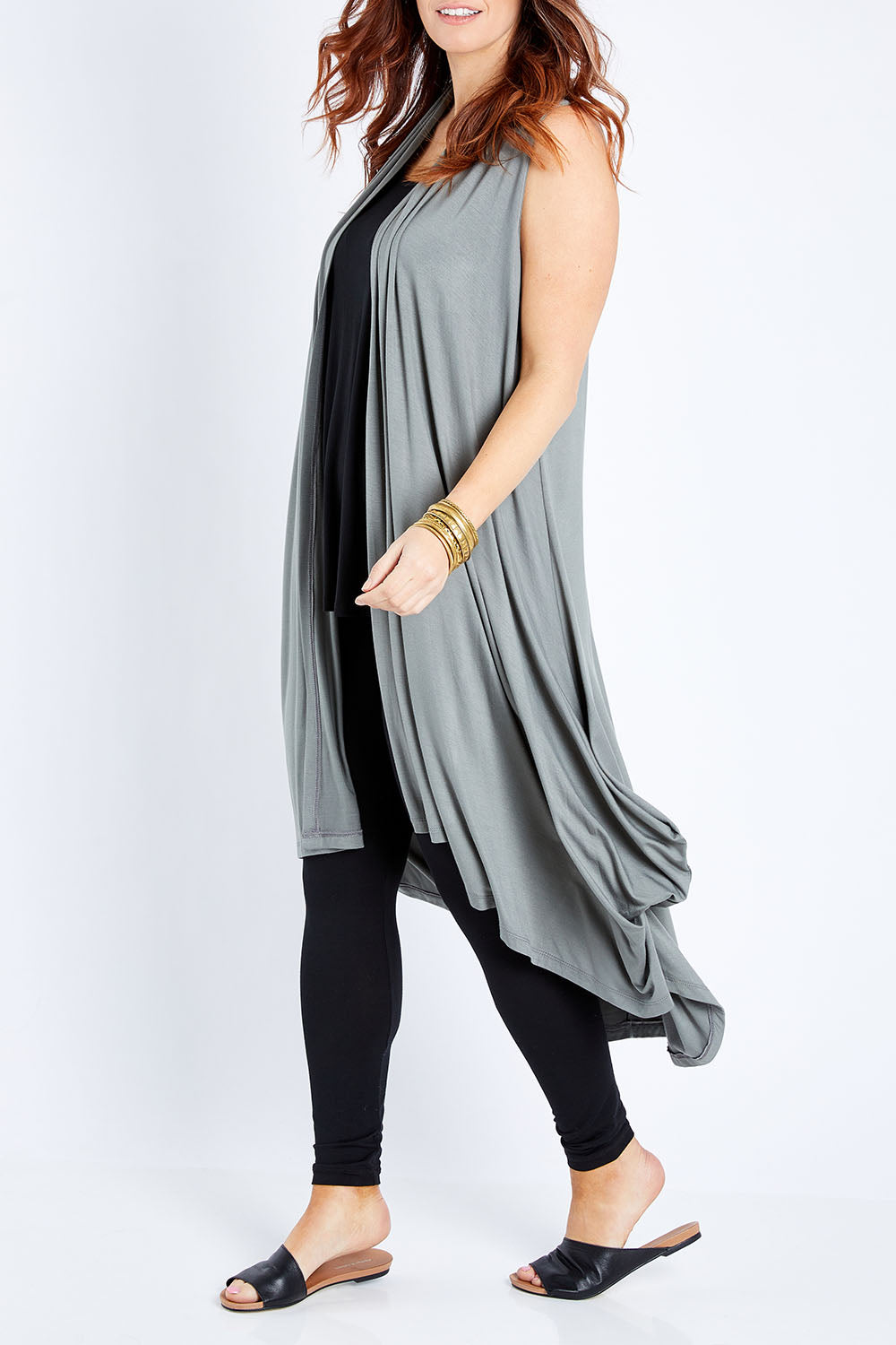 Model Laura wearing size 12 of the Softly Swinging Bamboo Vest in colour Fern (Green), from the front, cropped image
