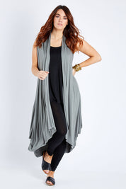 Model Laura wearing size 12 of the Softly Swinging Bamboo Vest in colour Fern (Green), from the front, showing the whole outfit