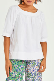 Model Olivia wearing size 10 of the Bliss Top in colour White (White), from the front, cropped image