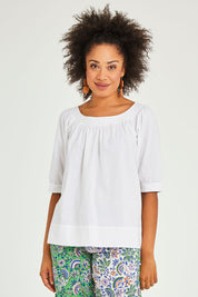 Model Olivia wearing size 10 of the Bliss Top in colour White (White), from the front, cropped image