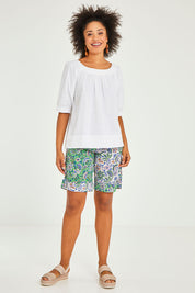 Model Olivia wearing size 10 of the Bliss Top in colour White (White), from the front, showing the whole outfit