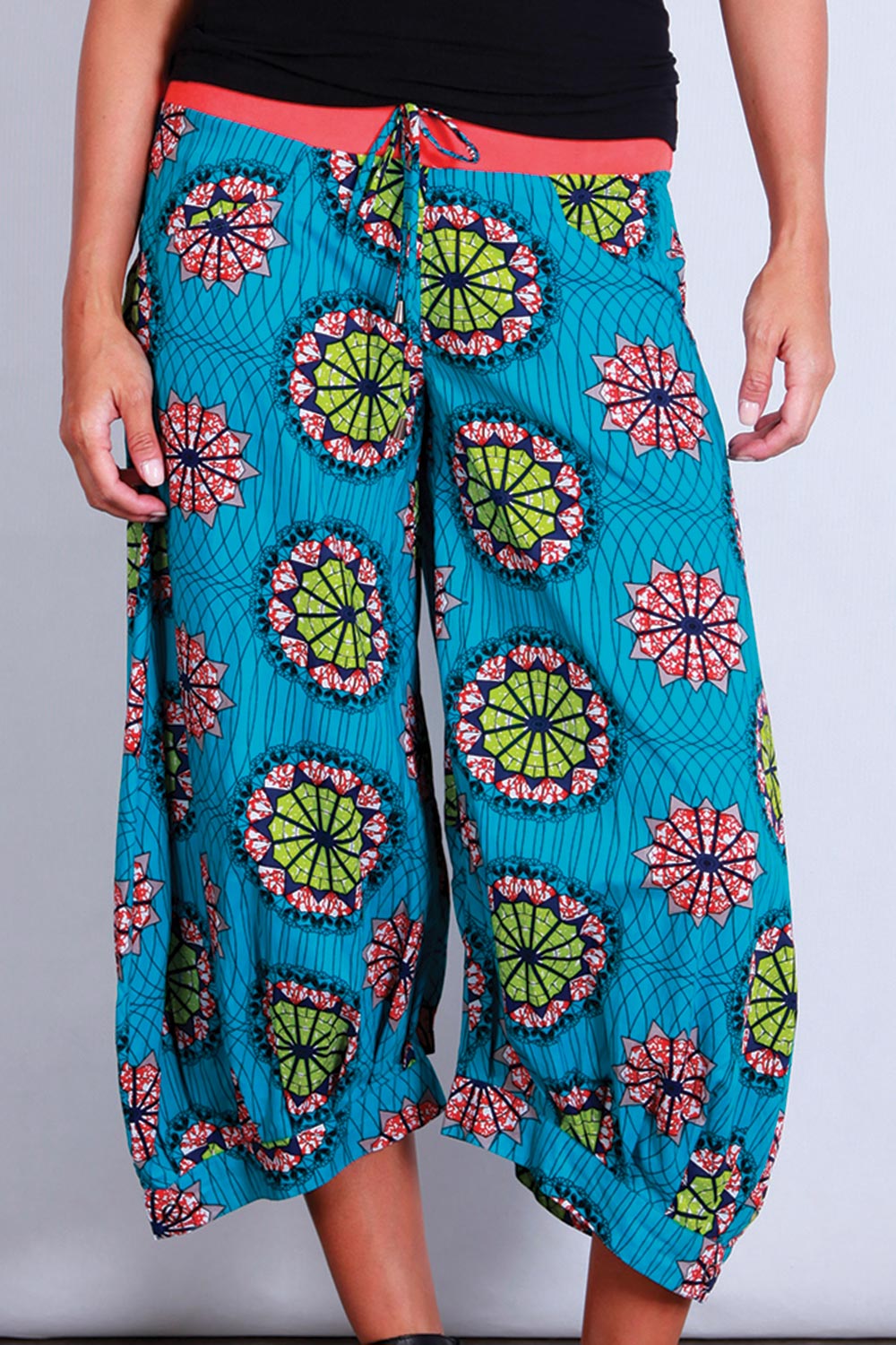 A model wearing the Guru Pants in colour AfriBlue (Blue), from the front, showing the whole outfit