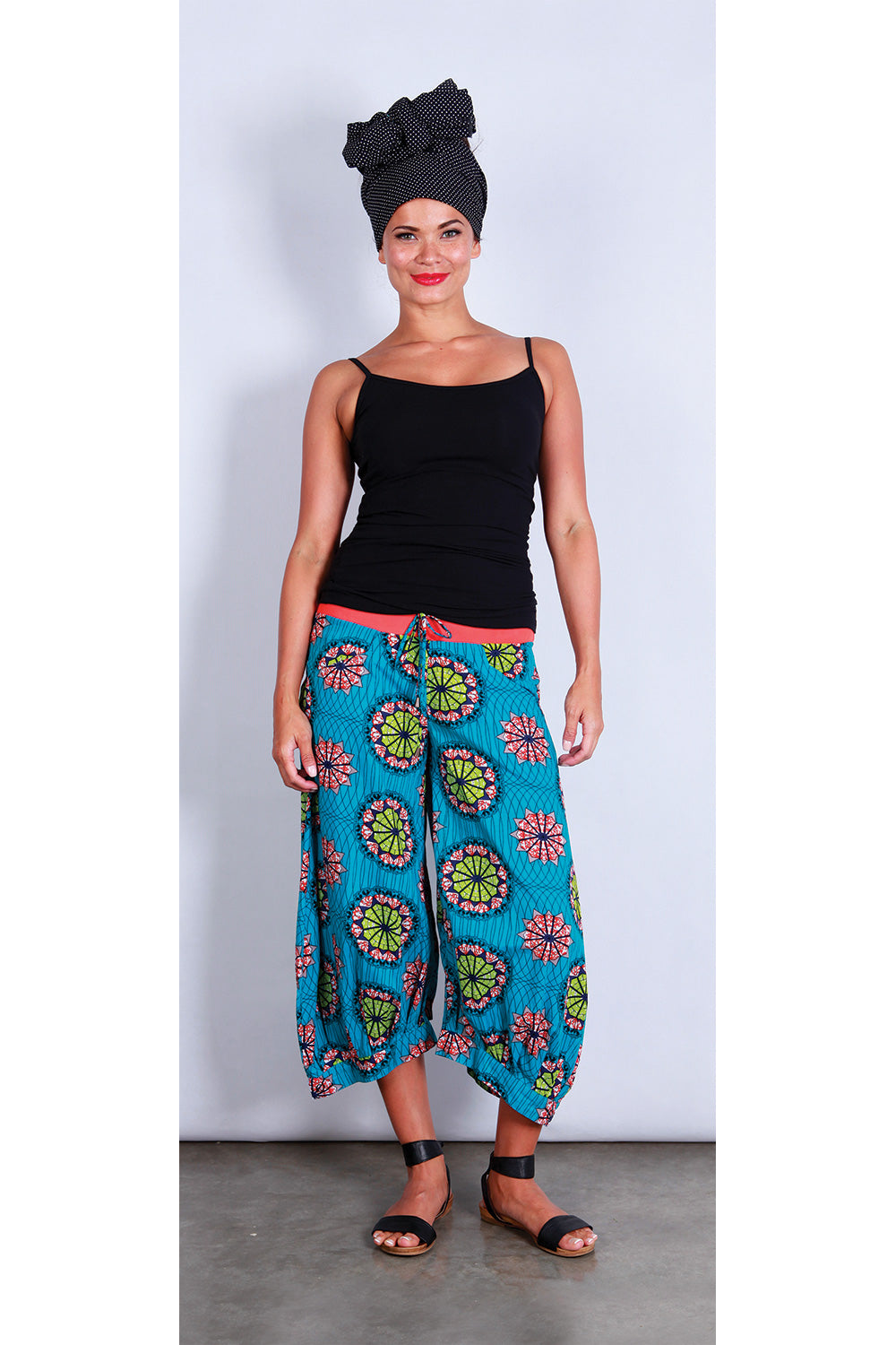 A model wearing the Guru Pants in colour AfriBlue (Blue), from the front, showing the whole outfit