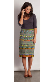 A model wearing the Pencil Cleo Skirt in colour Green (Green), from the front, showing the whole outfit