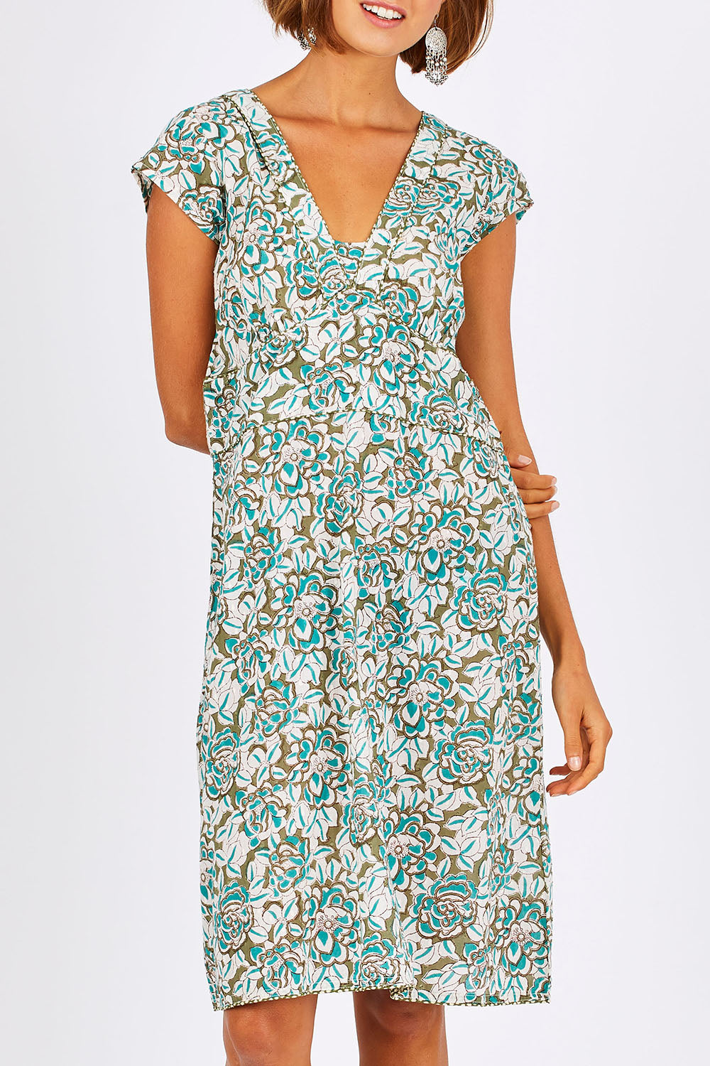 Model Nikki wearing size 10 of the Daisy Dress in colour Aqua (Blue), from the front, cropped image