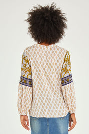 Model Olivia wearing size 10 of the Naina Top in colour Whitelyla (White), from the back