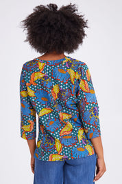 Model Olivia wearing size 10 of the Edith Top in colour Edith (Blue), from the back