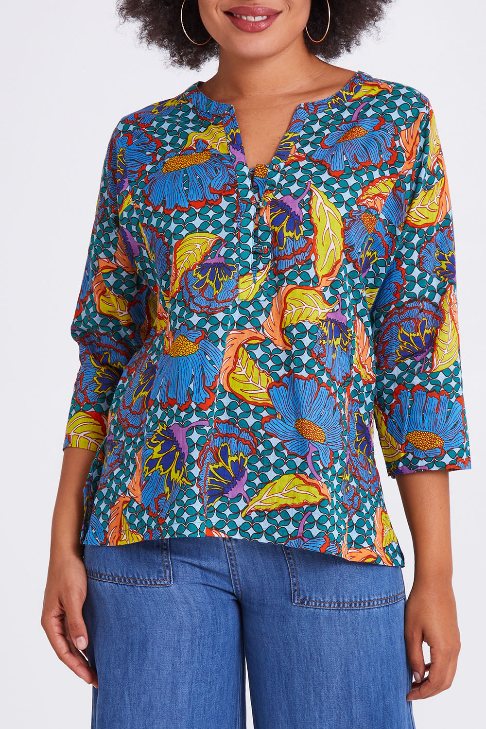 Model Olivia wearing size 10 of the Edith Top in colour Edith (Blue), from the front, cropped image
