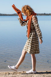 A model wearing size 10 of the Myrtle Dress in colour Banksia (Green), from the front, showing the whole outfit