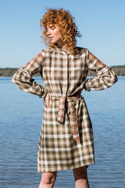 A model wearing size 10 of the Myrtle Dress in colour Banksia (Green), from the front, showing the whole outfit