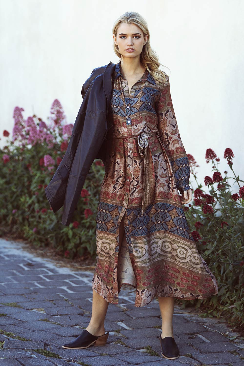 A model wearing the Safari Dress in colour Imperial (Pink), from the front, showing the whole outfit