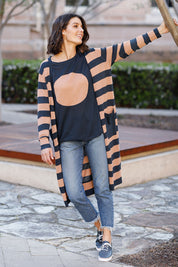 A model wearing the St Moritz Stripe Cardigan in colour Charclay (Grey), from the front, showing the whole outfit