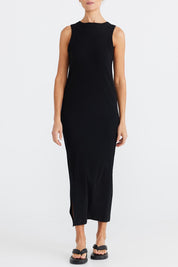 A model wearing the Carrie Dress in colour Black (Black), from the front, cropped image