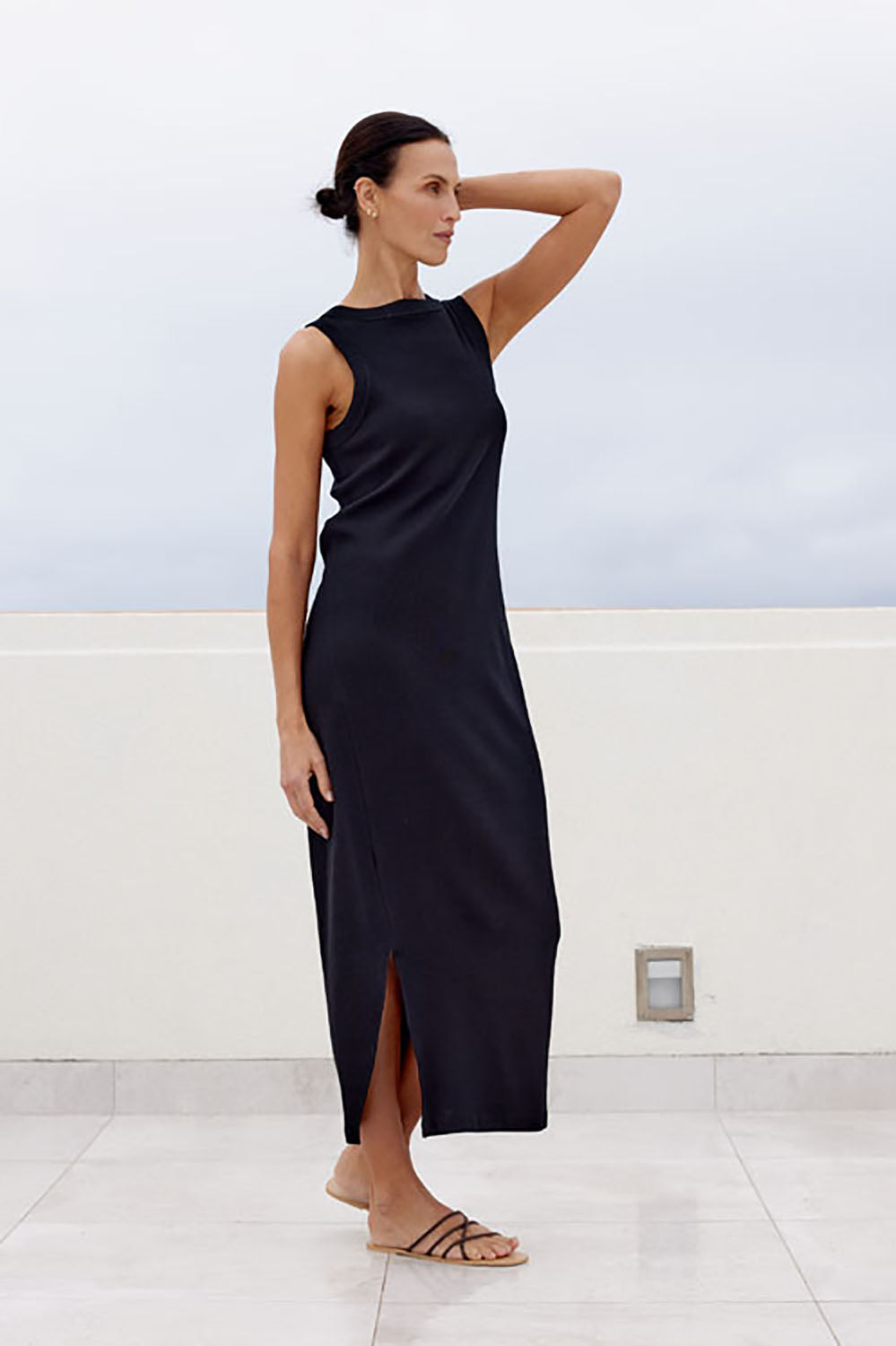A model wearing the Carrie Dress in colour Black (Black), from the front, showing the whole outfit