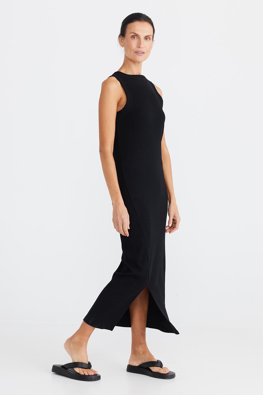 A model wearing the Carrie Dress in colour Black (Black), from the front, showing the whole outfit