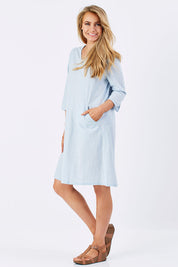 Model Marnee wearing size S of the Gela Dress in colour Sky (Blue), from the front, showing the whole outfit