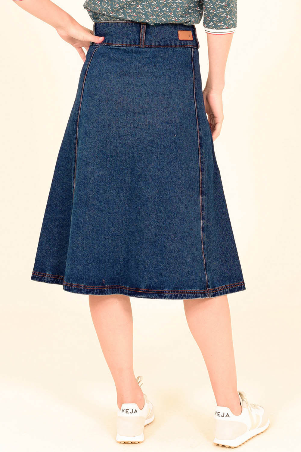A model wearing the Preloved Denim Circle Skirt in colour Blue (Blue), from the back