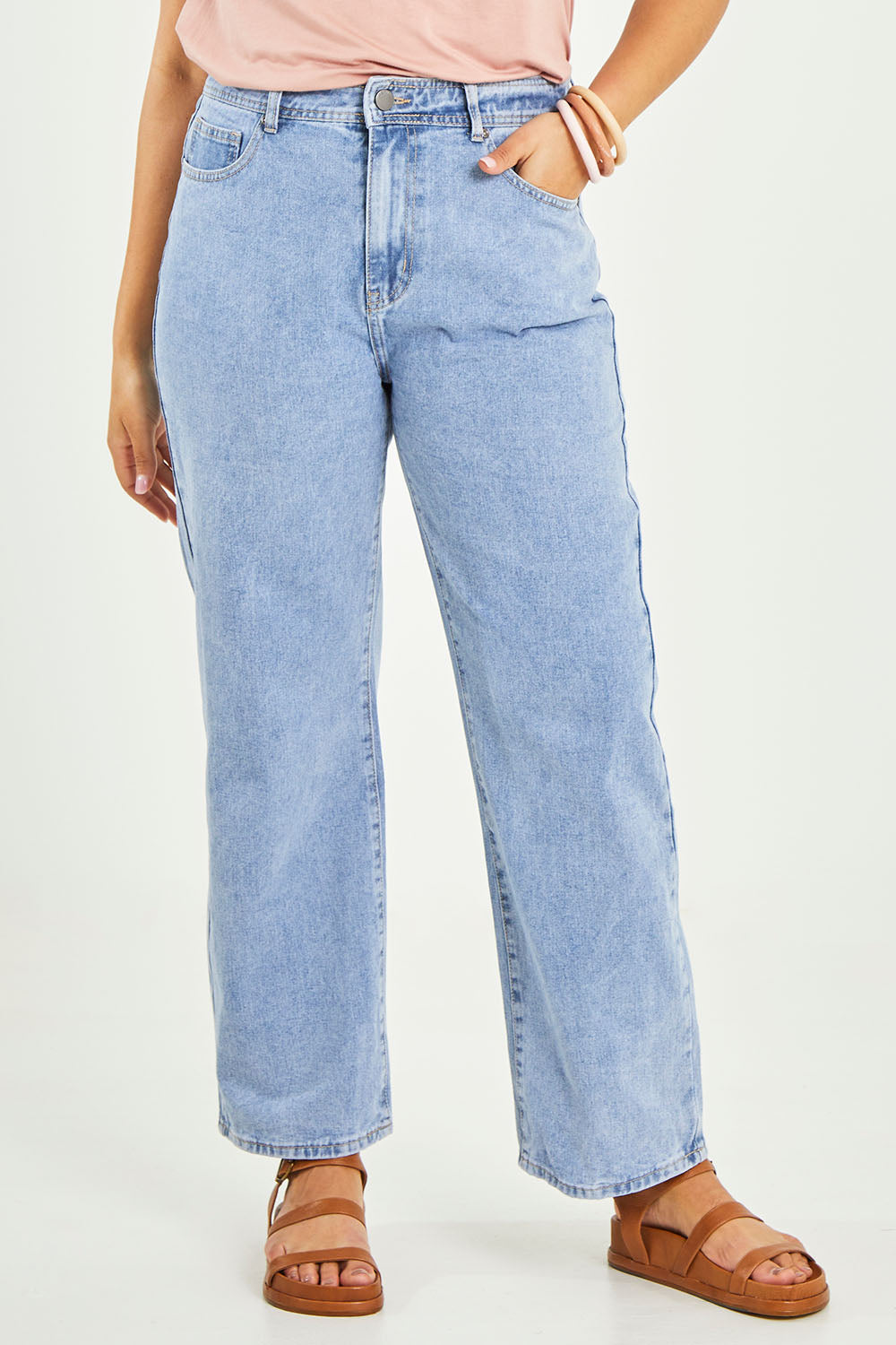 Model Terri-Leigh wearing size 14 of the Taylor Straight Jean in colour Midblue (Blue), from the front, cropped image