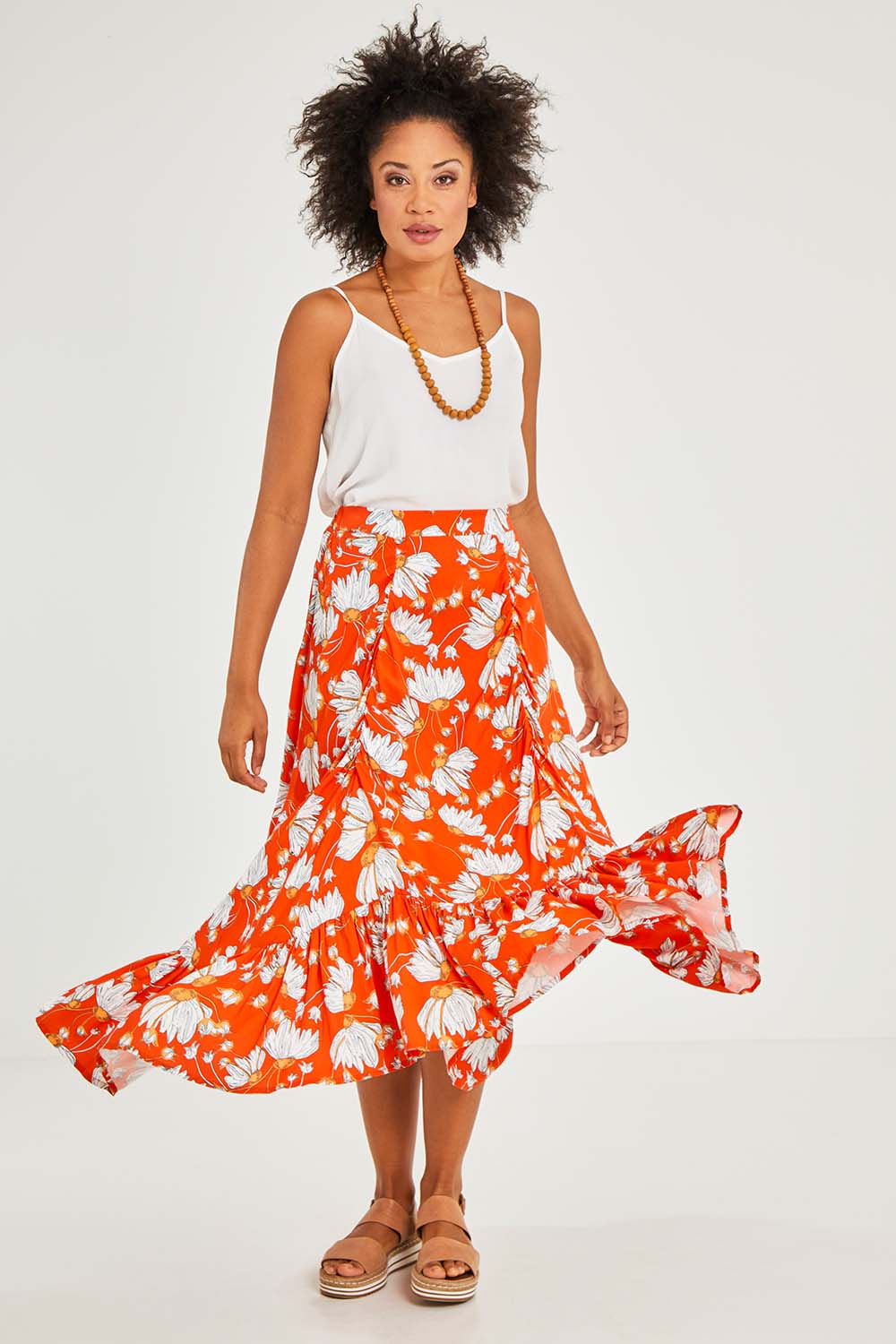 Model Olivia wearing size S of the Free Love Skirt in colour Sundance, from the front, showing the whole outfit