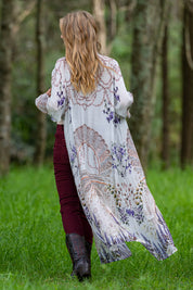 A model wearing the Lavender Duster in colour Lavender (White), from the back