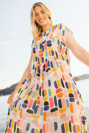 Model Phoebe wearing size S of the Abstract Print Dress in colour Multi (Blue), from the front, showing the whole outfit
