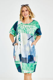 Model Jess wearing size L of the Pocket Print Dress in colour Multi (Green), from the front, cropped image