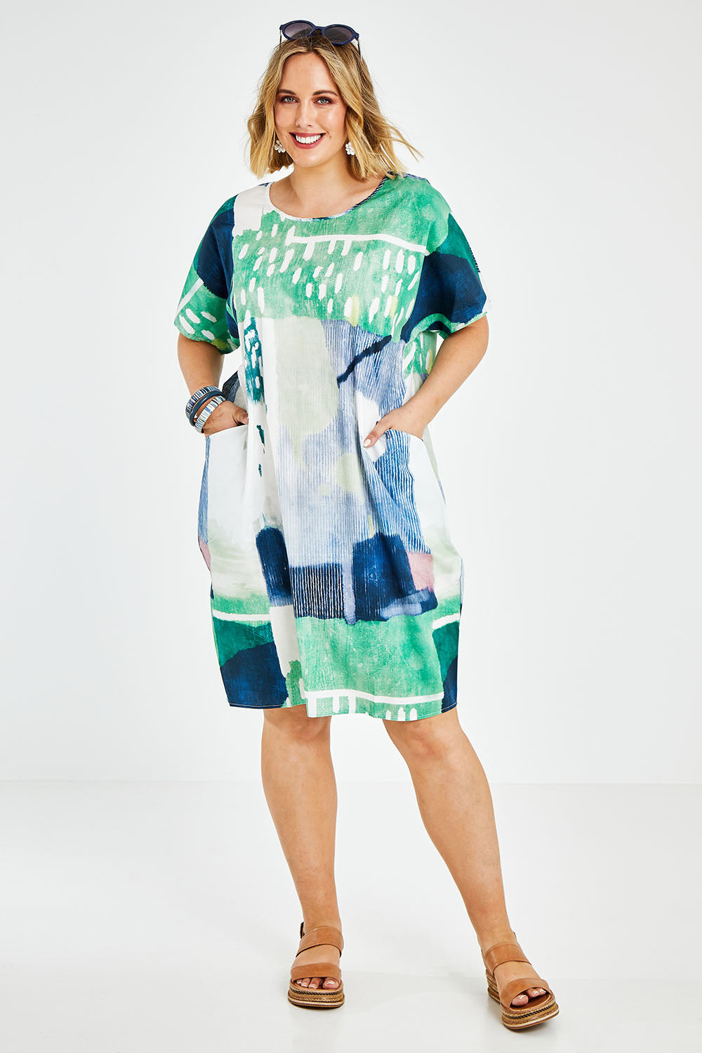 Model Jess wearing size L of the Pocket Print Dress in colour Multi (Green), from the front, showing the whole outfit