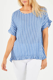 Model Kelly wearing size S of the Stripe Frilled Hem Top in colour Denim (Blue), from the front, cropped image