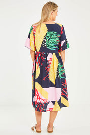Model Kelly wearing size S of the Under The Sea Print Dress in colour Navy (Blue), from the back