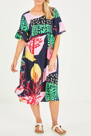 Model Kelly wearing size S of the Under The Sea Print Dress in colour Navy (Blue), from the front, cropped image