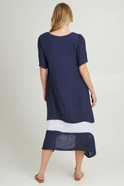 Model Grace wearing size S of the Envisage Dress in colour Navywhite (Blue), from the back