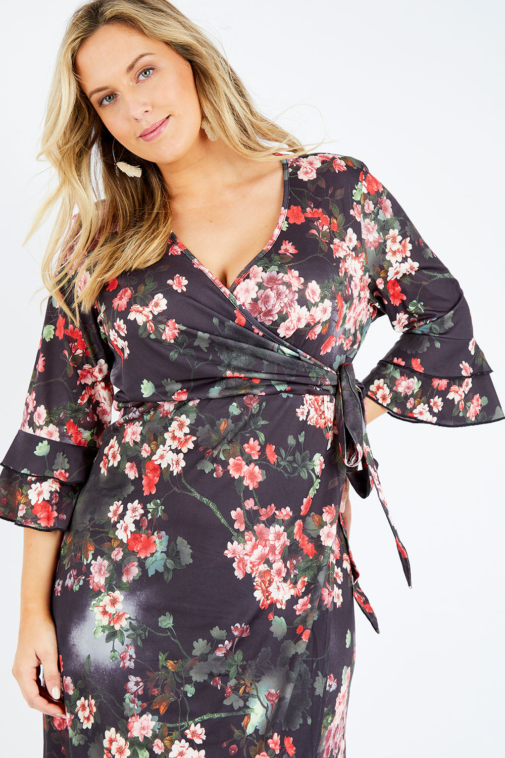 Model Jess wearing size 14 of the Wrap Dress in colour Floral (Black), from the front, cropped image