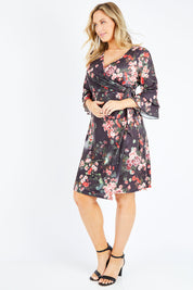 Model Jess wearing size 14 of the Wrap Dress in colour Floral (Black), from the front, showing the whole outfit