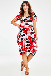 Model Laura wearing size 14 of the Cap Sleeve Bounce Dress in colour Red (Red), from the front, showing the whole outfit