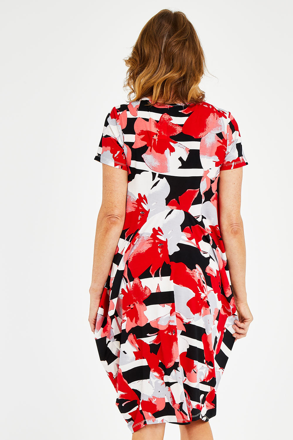 Model Naomi wearing size 10 of the Cap Sleeve Bounce Dress in colour Red (Red), from the back