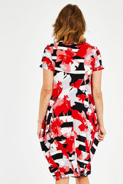 Model Naomi wearing size 10 of the Cap Sleeve Bounce Dress in colour Red (Red), from the back